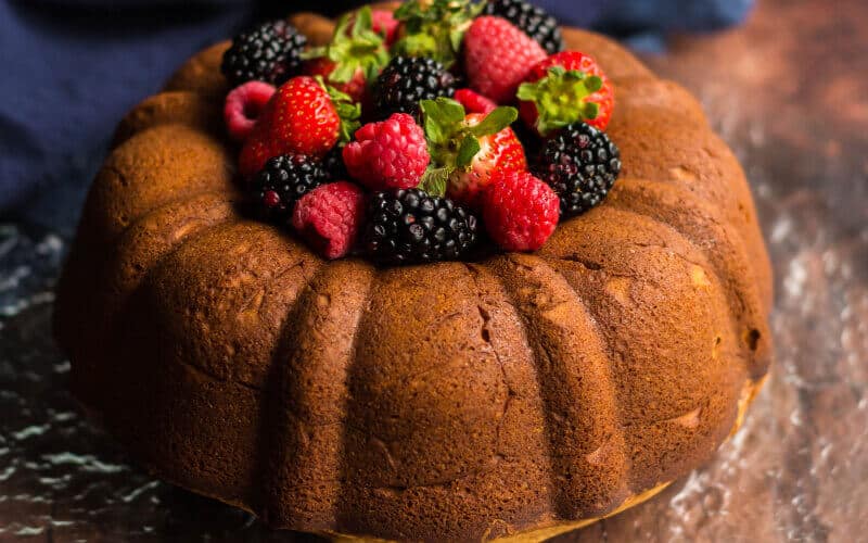 cream cheese pound cake with raspberries and blackberries on top