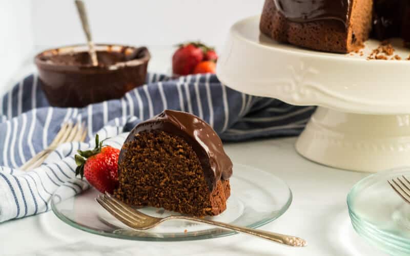 piece of chocolate sour cream pound cake with strawberry white cake plate