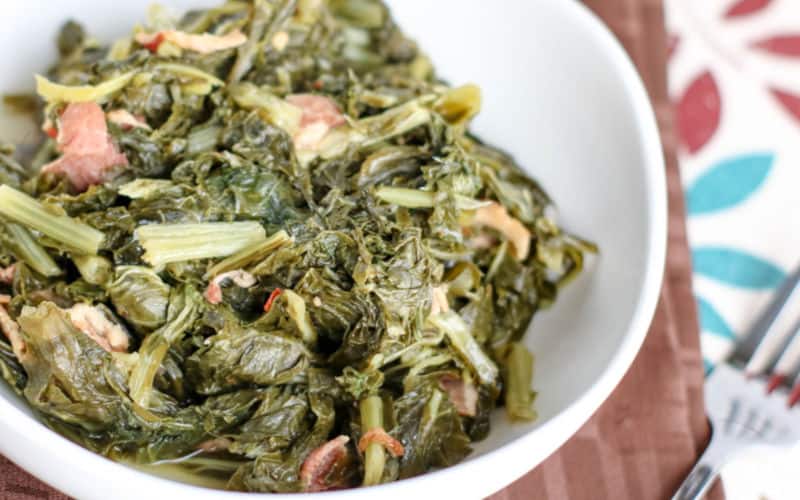 instant pot turnip greens with bacon close up in white bowl on wooden table