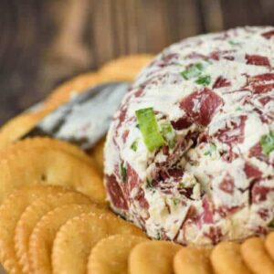 dried beef cheese ball with ritz crackers on table