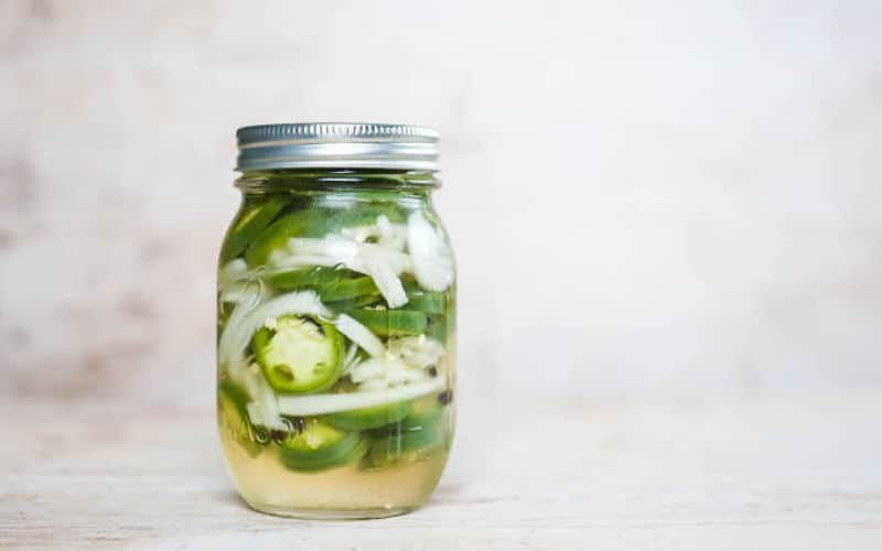 jar of quick pickled jalapenos on table
