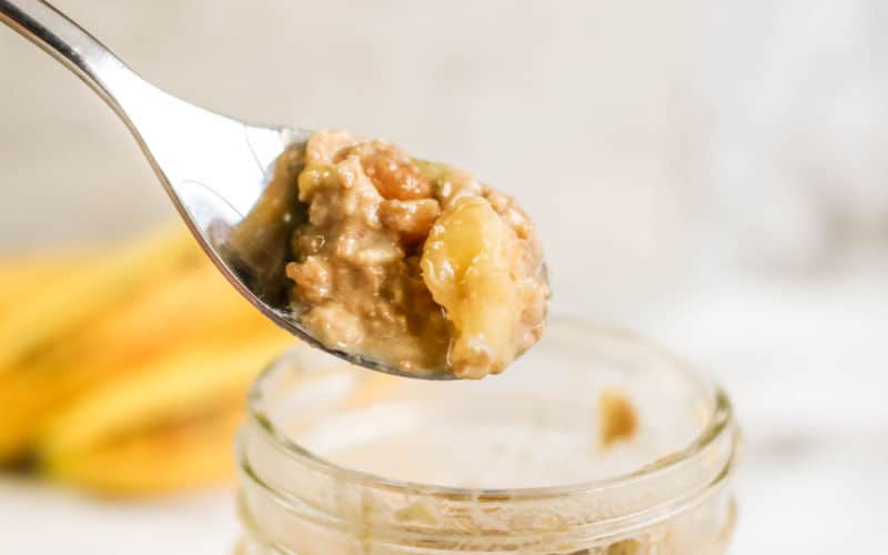 peanut butter overnight oats on a spoon above a jar