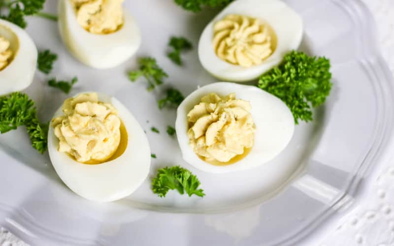 hard boiled egg on plate with parsley