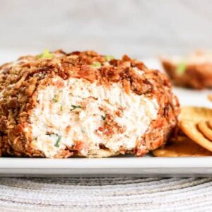 bacon cheese ball on platter with crackers