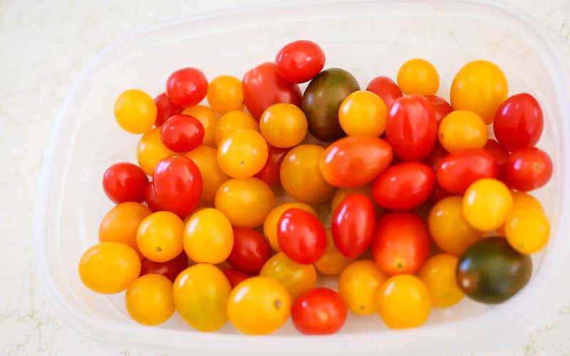 cherry tomatoes in container ready to be pickled