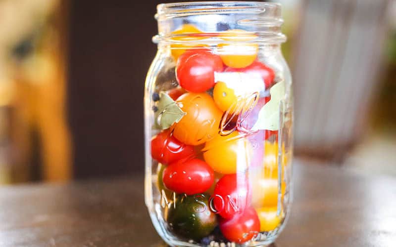 pickled cherry tomatoes in a ball mason jar