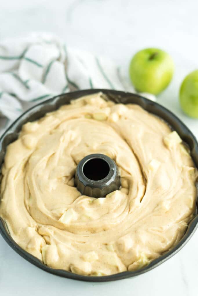 apple pound cake batter in a bundt pan