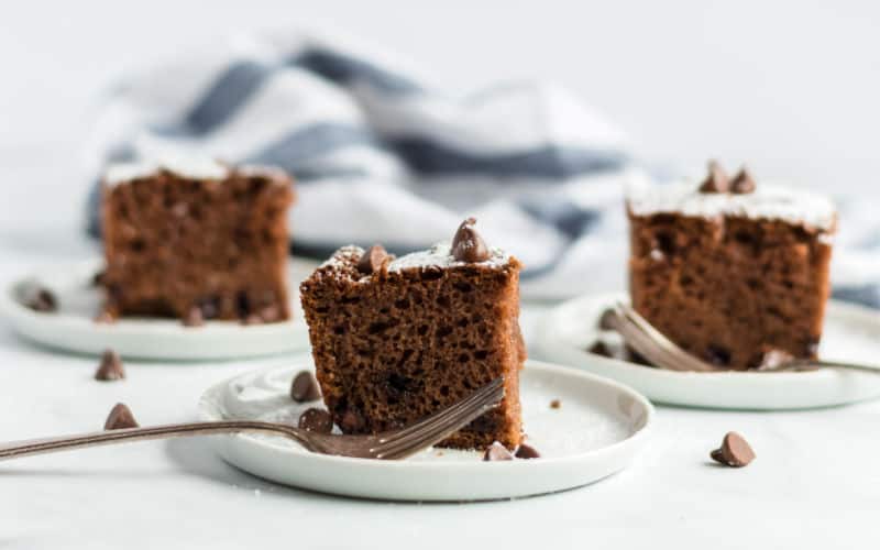 three pieces of chocolate chip cake on white plates