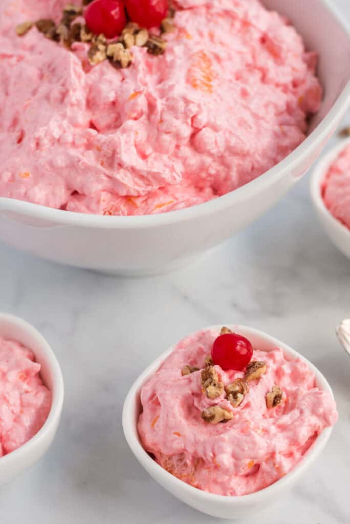 close up shot of pink salad in white bowl on marble table