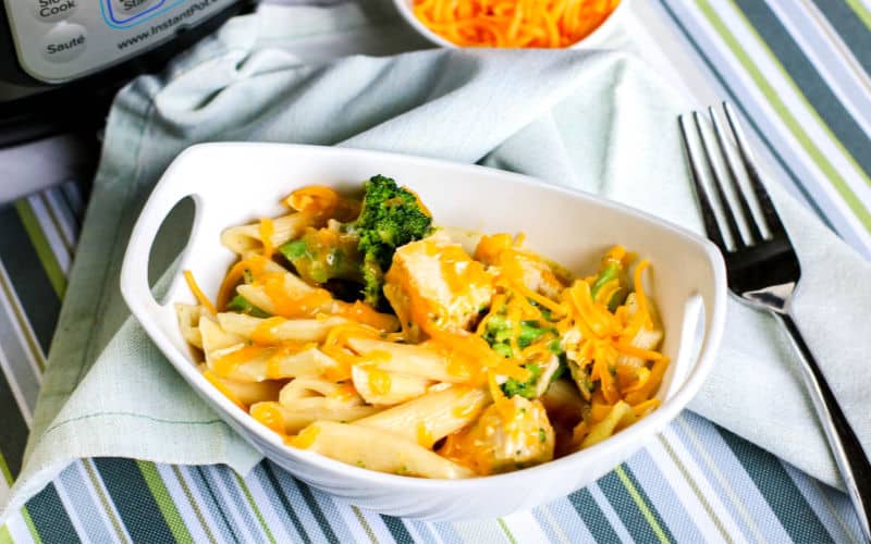penne pasta with chicken and broccoli in a white bowl
