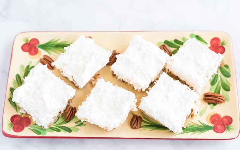 white Christmas cake cut in squares on a Christmas platter