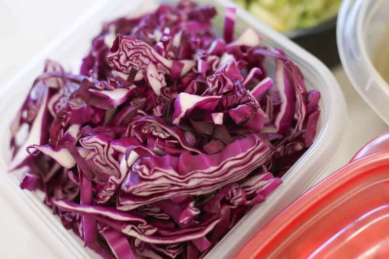 shredded cabbage in a plastic container ready to put in jars
