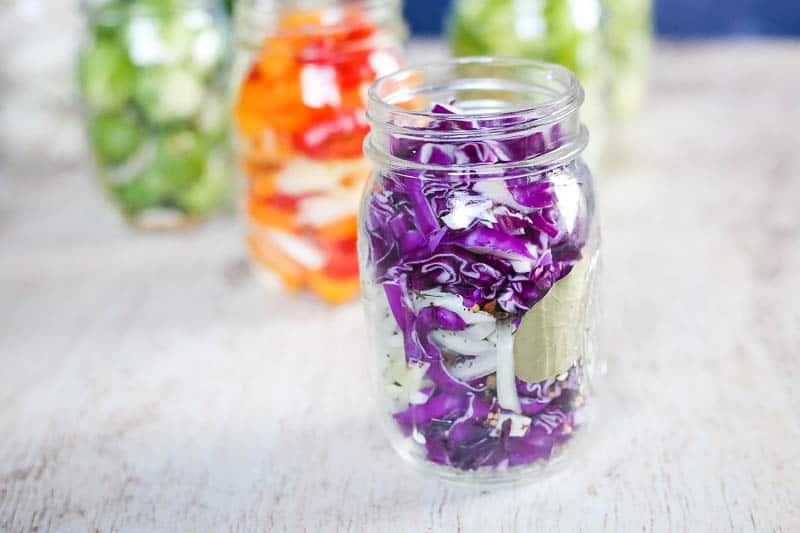 shredded cabbage in a jar with spices ready to quick pickle