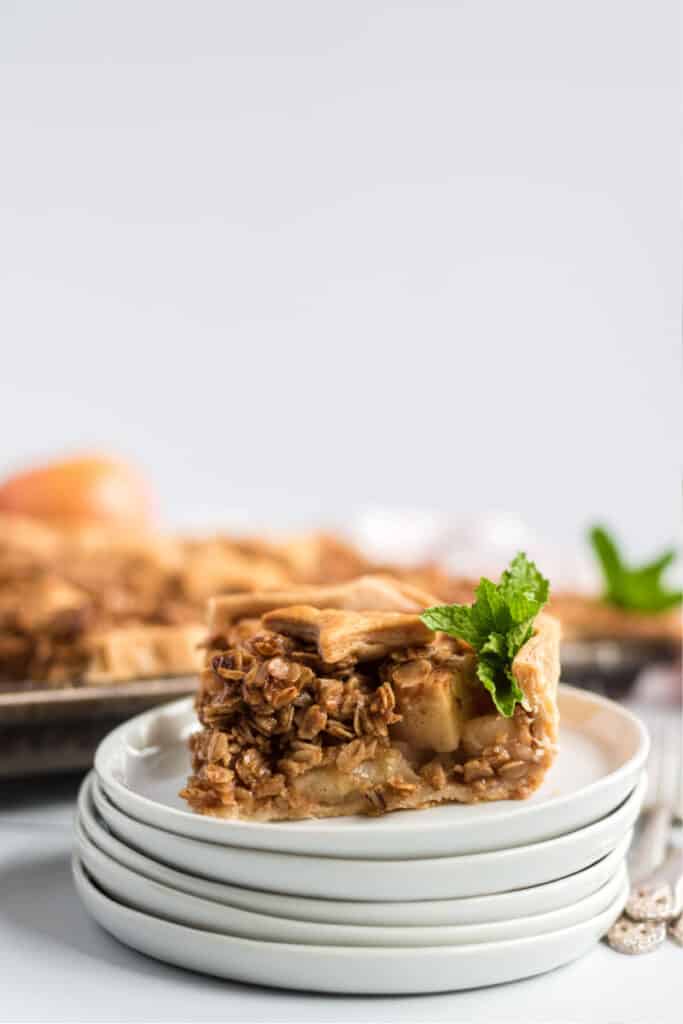 lovely apple slab pie on stacked white plates