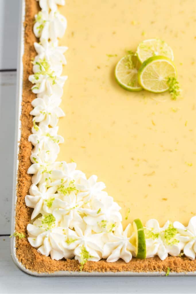 key lime slab pie with key limes and whipped cream