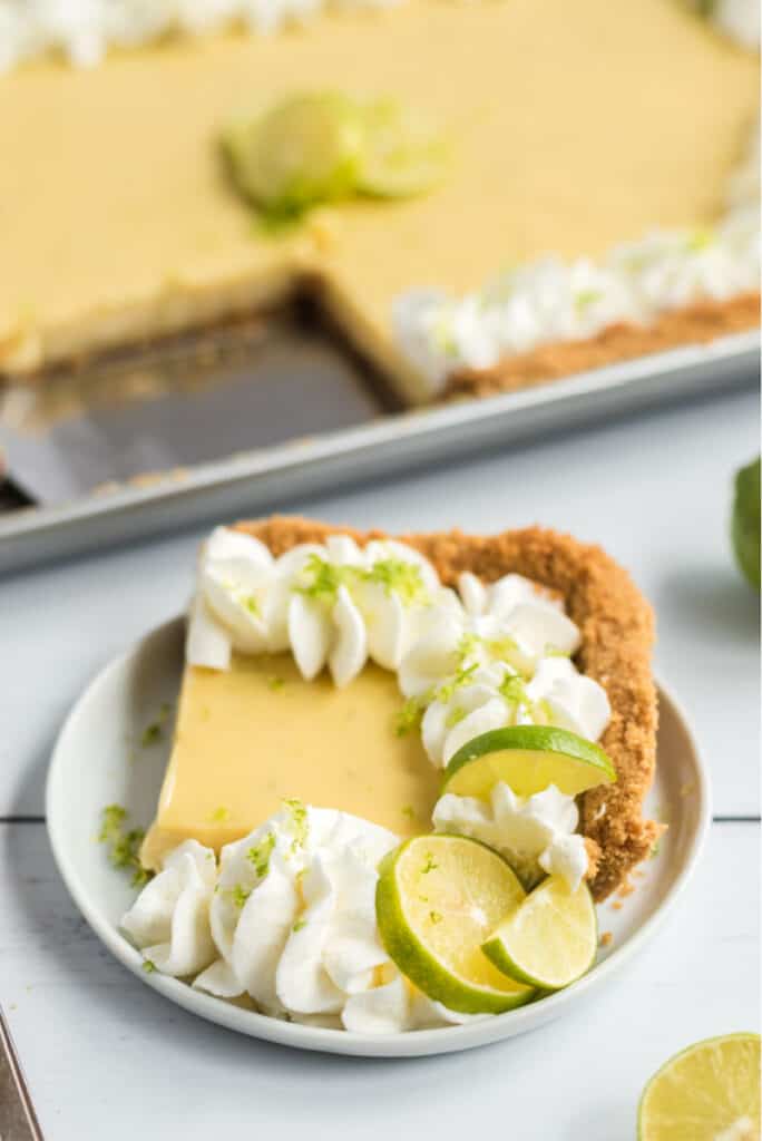 key lime pie on white plate with lime zest shavings