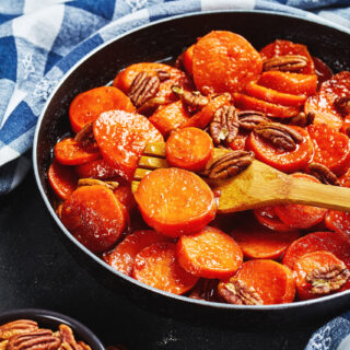 Candied sweet potatoes in a frying pan